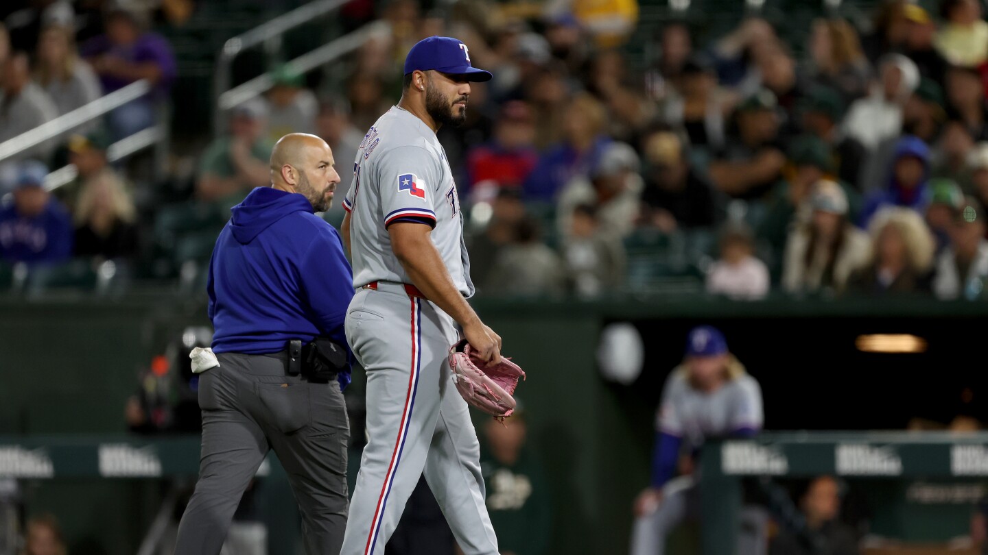 Rangers reliever Luis Curvelo hurt while delivering a wild pitch against the Athletics